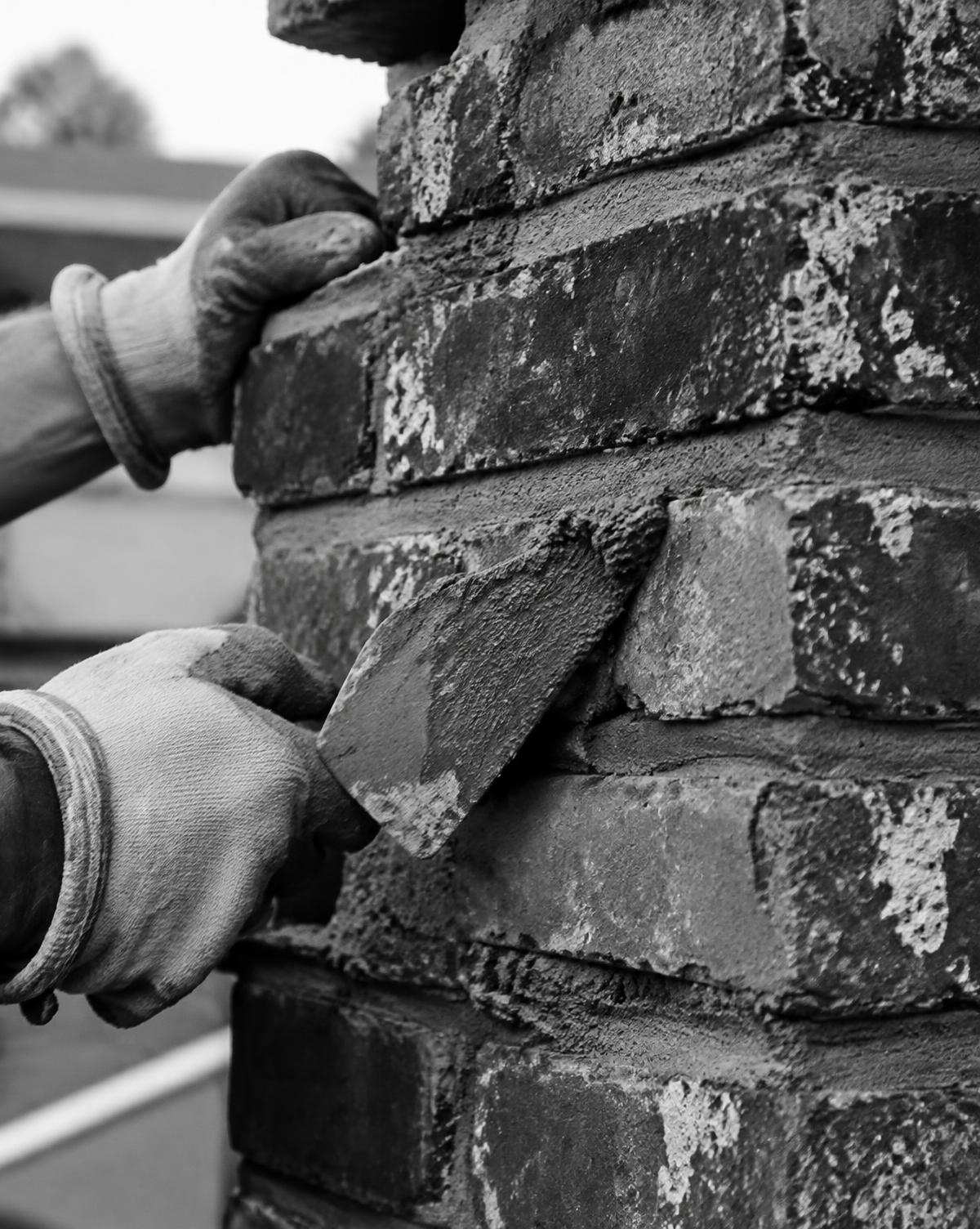Mortar being applied between chimney bricks